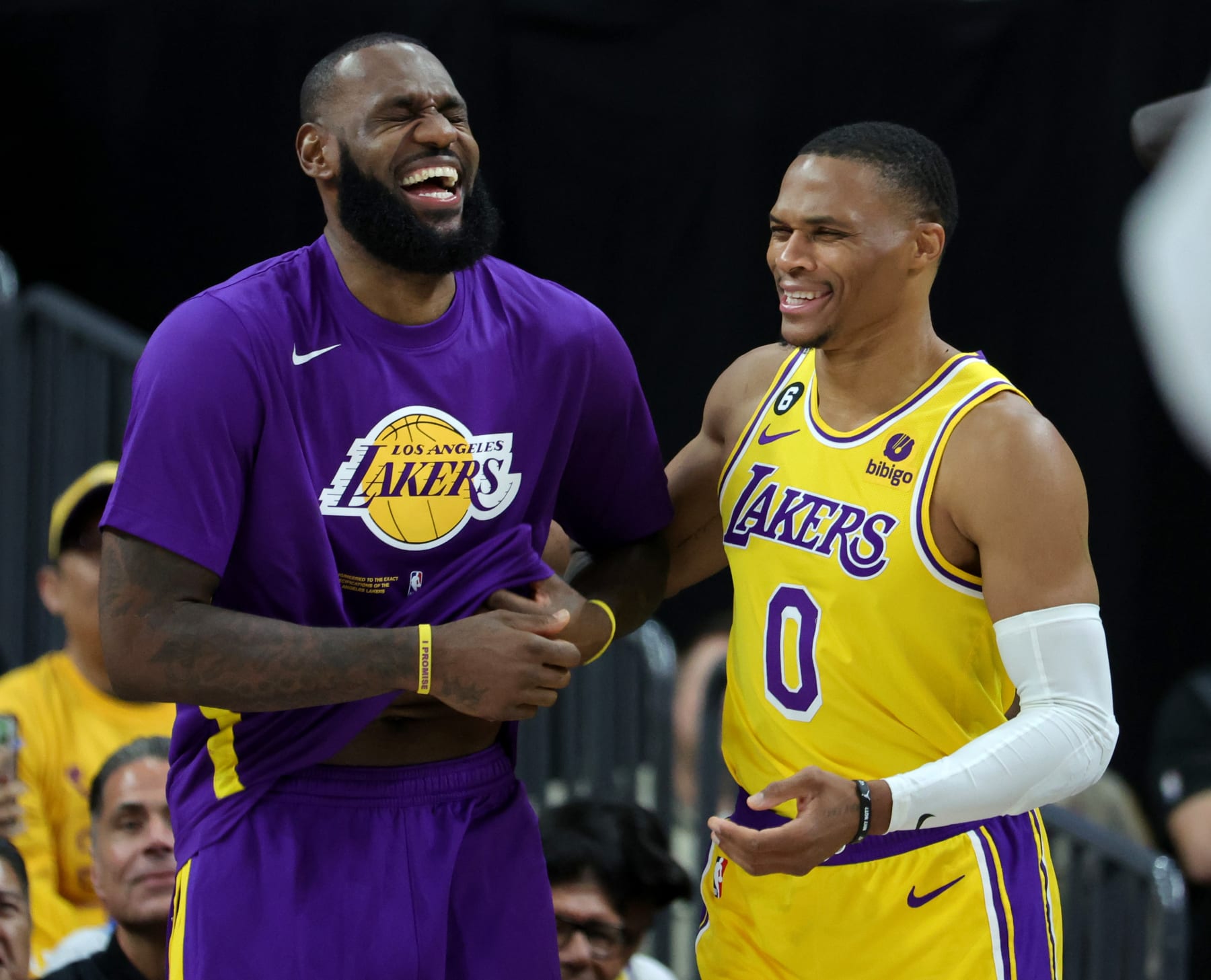 LAS VEGAS, NEVADA - OCTOBER 05: LeBron James #6 and Russell Westbrook #0 of the Los Angeles Lakers laugh on the sideline after Westbrook was called for a technical foul on the bench in the third quarter of their preseason game against the Phoenix Suns at T-Mobile Arena on October 05, 2022 in Las Vegas, Nevada. The Suns defeated the Lakers 119-115. NOTE TO USER: User expressly acknowledges and agrees that, by downloading and or using this photograph, User is consenting to the terms and conditions of the Getty Images License Agreement. (Photo by Ethan Miller/Getty Images)