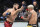 ABU DHABI, UNITED ARAB EMIRATES - OCTOBER 22: (L-R) Islam Makhachev of Russia punches Charles Oliveira of Brazil in their UFC lightweight championship fight during the UFC 280 event at Etihad Arena on October 22, 2022 in Abu Dhabi, United Arab Emirates. (Photo by Chris Unger/Zuffa LLC)