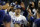 Los Angeles Dodgers' Trea Turner (6) celebrates in the dugout after scoring off of a double hit by Freddie Freeman during the eighth inning of a baseball game against the Milwaukee Brewers in Los Angeles, Tuesday, Aug. 23, 2022. Mookie Betts also scored. (AP Photo/Ashley Landis)