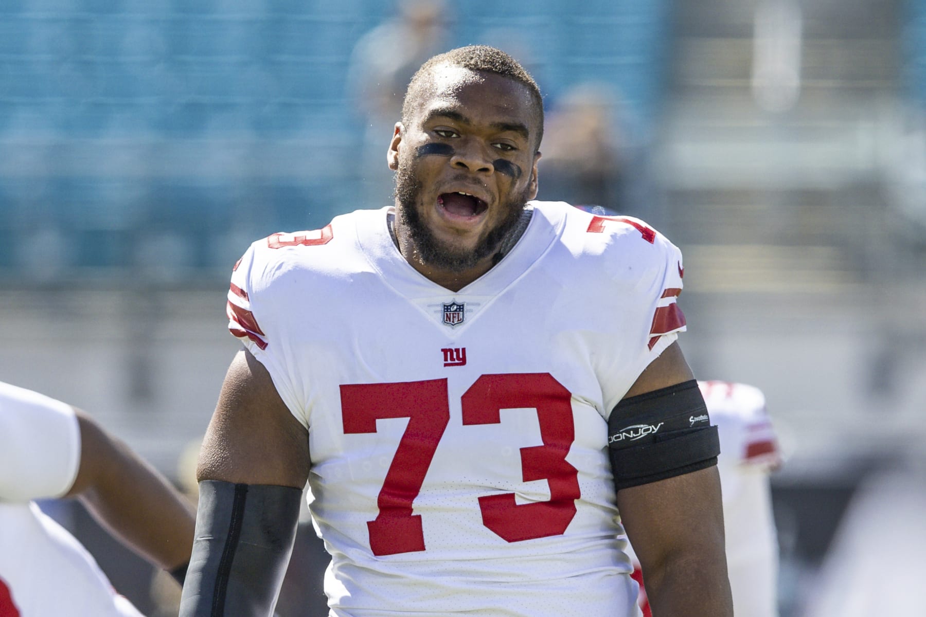 New York Giants offensive tackle Evan Neal (73) talks with a teammate during warm-ups before an NFL football game against the Jacksonville Jaguars on Sunday, Oct. 23, 2022, in Jacksonville, Fla. (AP Photo/Gary McCullough)