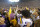 LSU offensive lineman Fitzgerald West Jr. (68) and linebacker DeMario Tolan (32) celebrate with fans who stormed the field after an NCAA college football game against Alabama in Baton Rouge, La., Saturday, Nov. 5, 2022. LSU won 32-31 in overtime. (AP Photo/Tyler Kaufman)