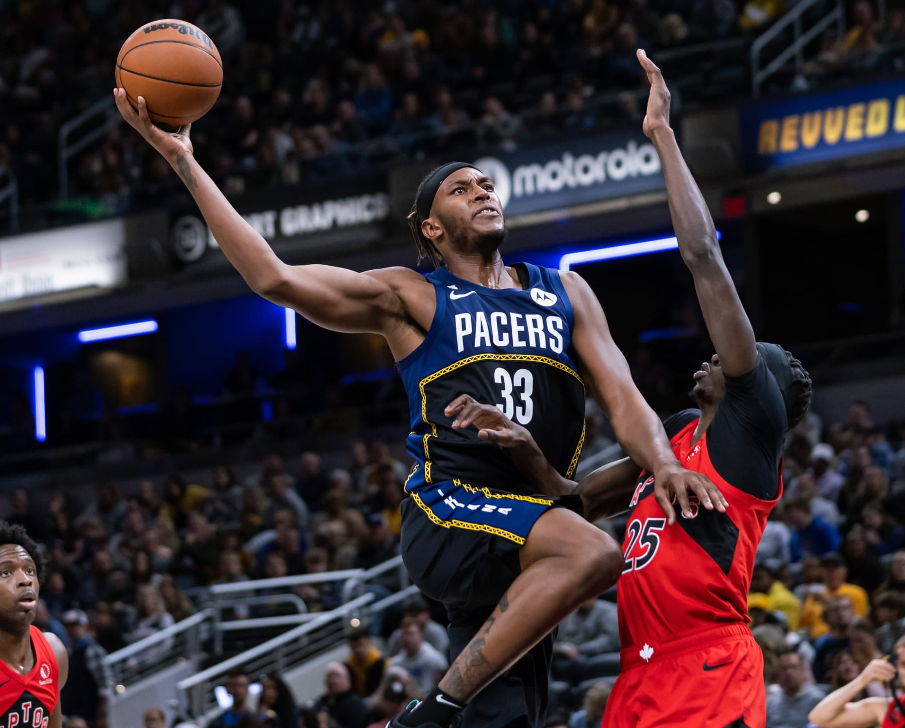 INDIANAPOLIS, IN - NOVEMBER 12: Myles Turner #33 of the Indiana Pacers shoots the ball against Chris Boucher #25 of the Toronto Raptors at Gainbridge Fieldhouse on November 12, 2022 in Indianapolis, Indiana. NOTE TO USER: User expressly acknowledges and agrees that, by downloading and or using this photograph, User is consenting to the terms and conditions of the Getty Images License Agreement. (Photo by Michael Hickey/Getty Images)