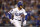 LOS ANGELES, CALIFORNIA - OCTOBER 11: Cody Bellinger #35 of the Los Angeles Dodgers reaches first base on a fielding error by the San Diego Padres during the third inning in game one of the National League Division Series at Dodger Stadium on October 11, 2022 in Los Angeles, California. (Photo by Ronald Martinez/Getty Images)