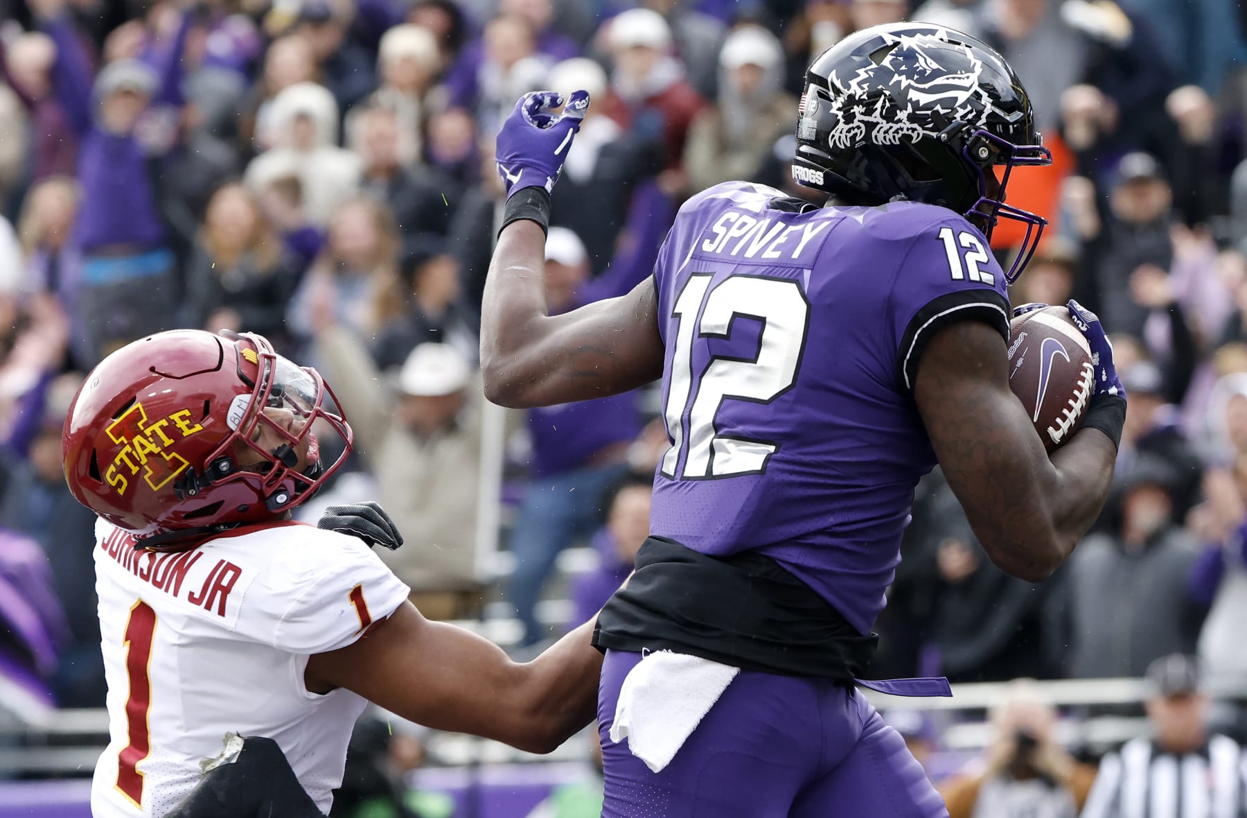 FORT WORTH, TX - NOVEMBER 26: Tight end Geor'Quarius Spivey #12 of the TCU Horned Frogs catches a touchdown pass as defensive back Anthony Johnson Jr. #1 of the Iowa State Cyclones defends during the first half at Amon G. Carter Stadium on November 26, 2022 in Fort Worth, Texas. (Photo by Ron Jenkins/Getty Images)