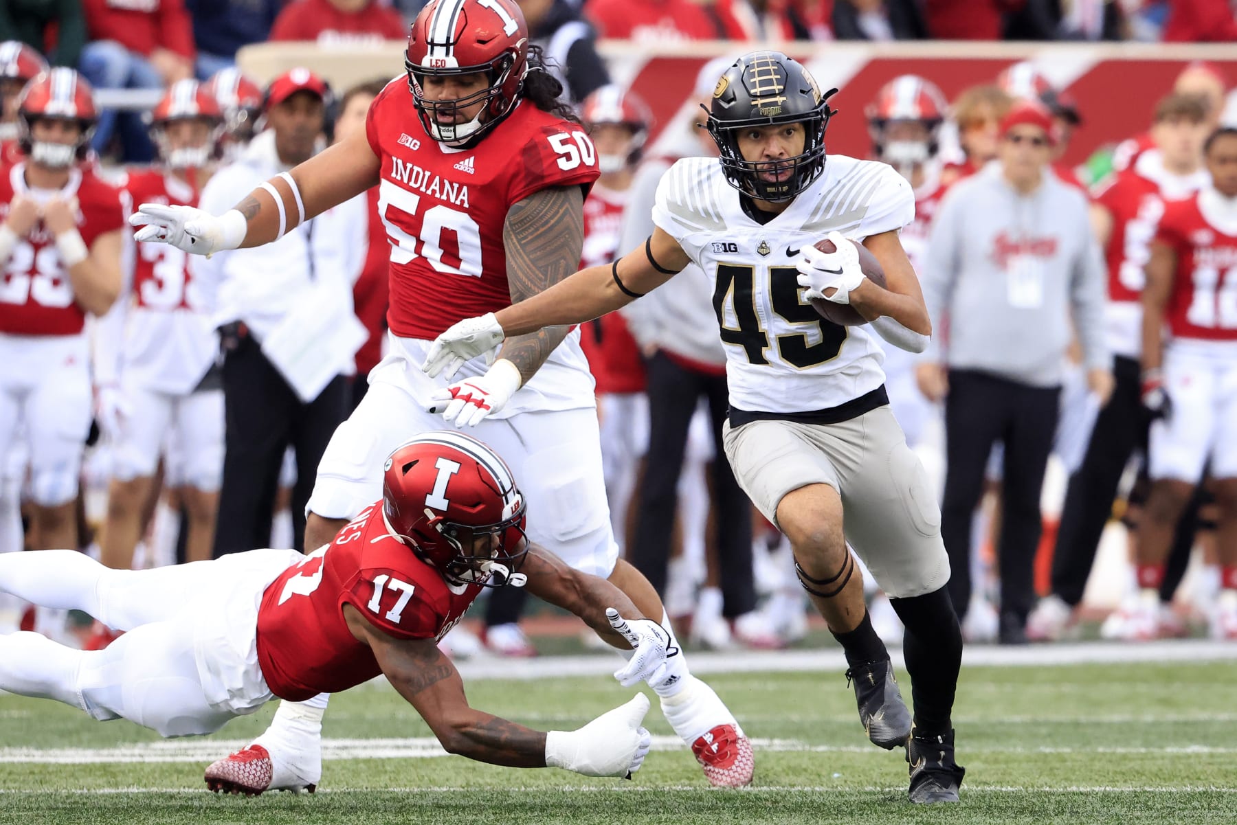 BLOOMINGTON, INDIANA - NOVEMBER 26: Devin Mockobee #45 of the Purdue Boilermakers avoids a tackle from Jonathan Haynes #17 of the Indiana Hoosiers during the first half at Memorial Stadium on November 26, 2022 in Bloomington, Indiana. (Photo by Justin Casterline/Getty Images)