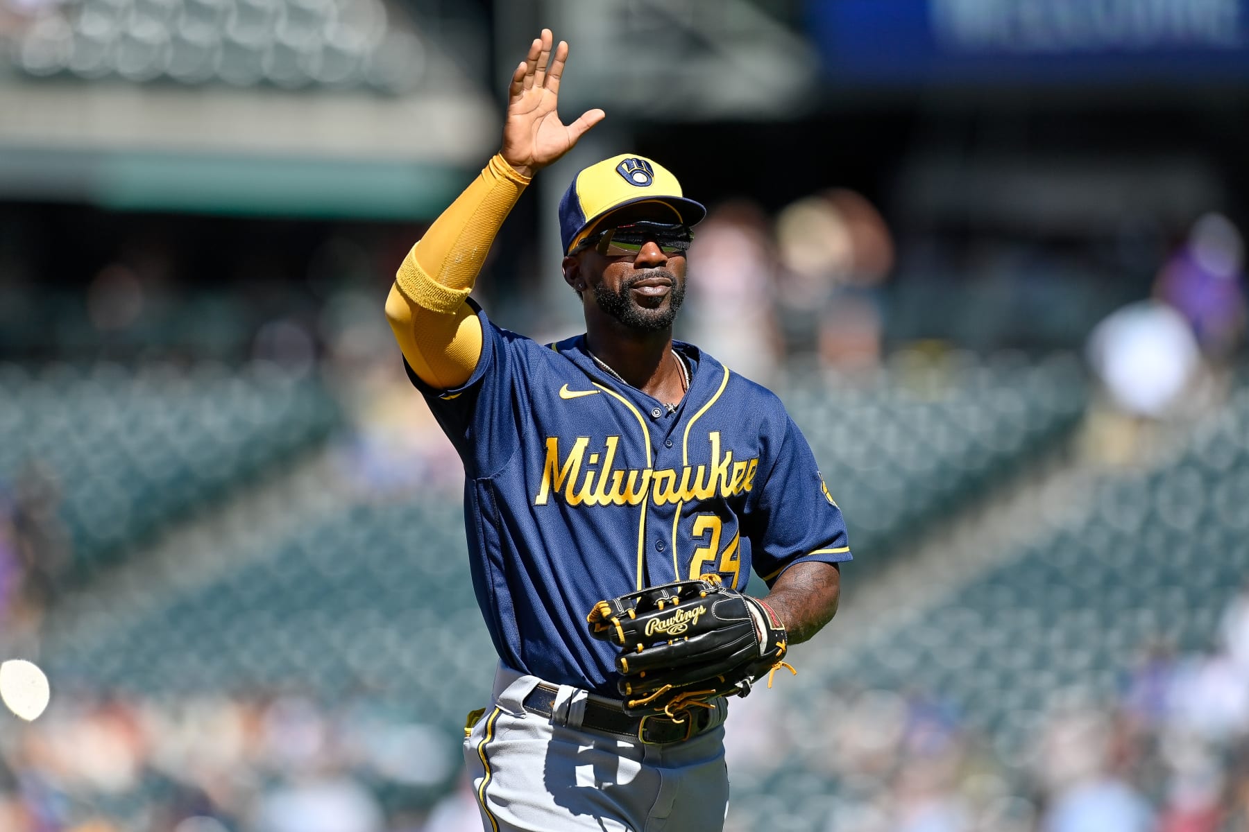 DENVER, CO - SEPTEMBER 5: Andrew McCutchen #24 of the Milwaukee Brewers waves towards the stands as he returns to the dugout after playing defense in the third inning of a game against the Colorado Rockies at Coors Field on September 5, 2022 in Denver, Colorado. (Photo by Dustin Bradford/Getty Images)