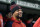 Boston Red Sox's Xander Bogaerts wears a winter hat as he looks on from the dugout during the ninth inning of a baseball game against the Tampa Bay Rays at Fenway Park, Monday, Oct. 3, 2022, in Boston. (AP Photo/Mary Schwalm)