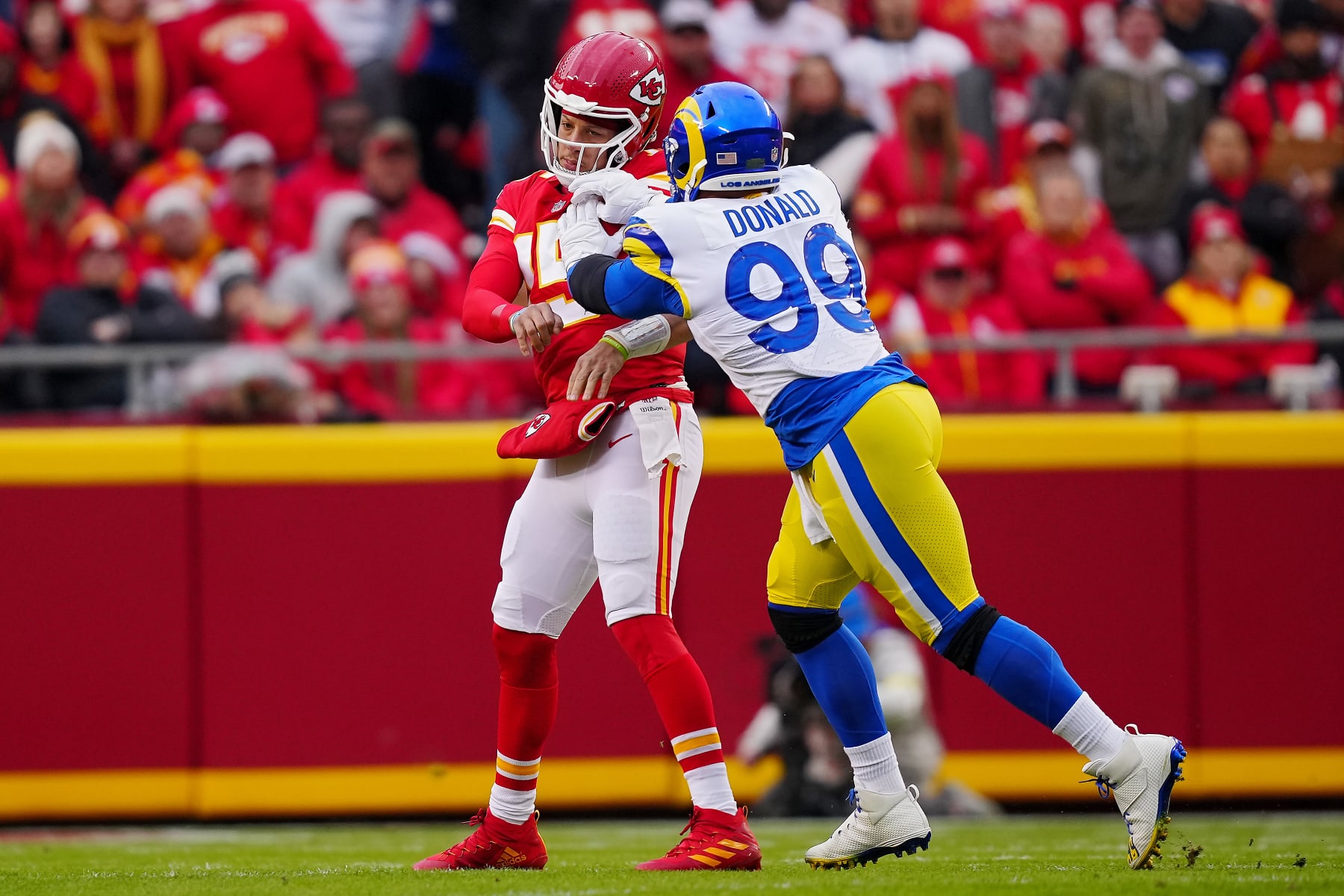 KANSAS CITY, MISSOURI - NOVEMBER 27: Patrick Mahomes #15 of the Kansas City Chiefs is pressured after a pass by Aaron Donald #99 of the Los Angeles Rams during the first quarter at Arrowhead Stadium on November 27, 2022 in Kansas City, Missouri. (Photo by Jason Hanna/Getty Images)