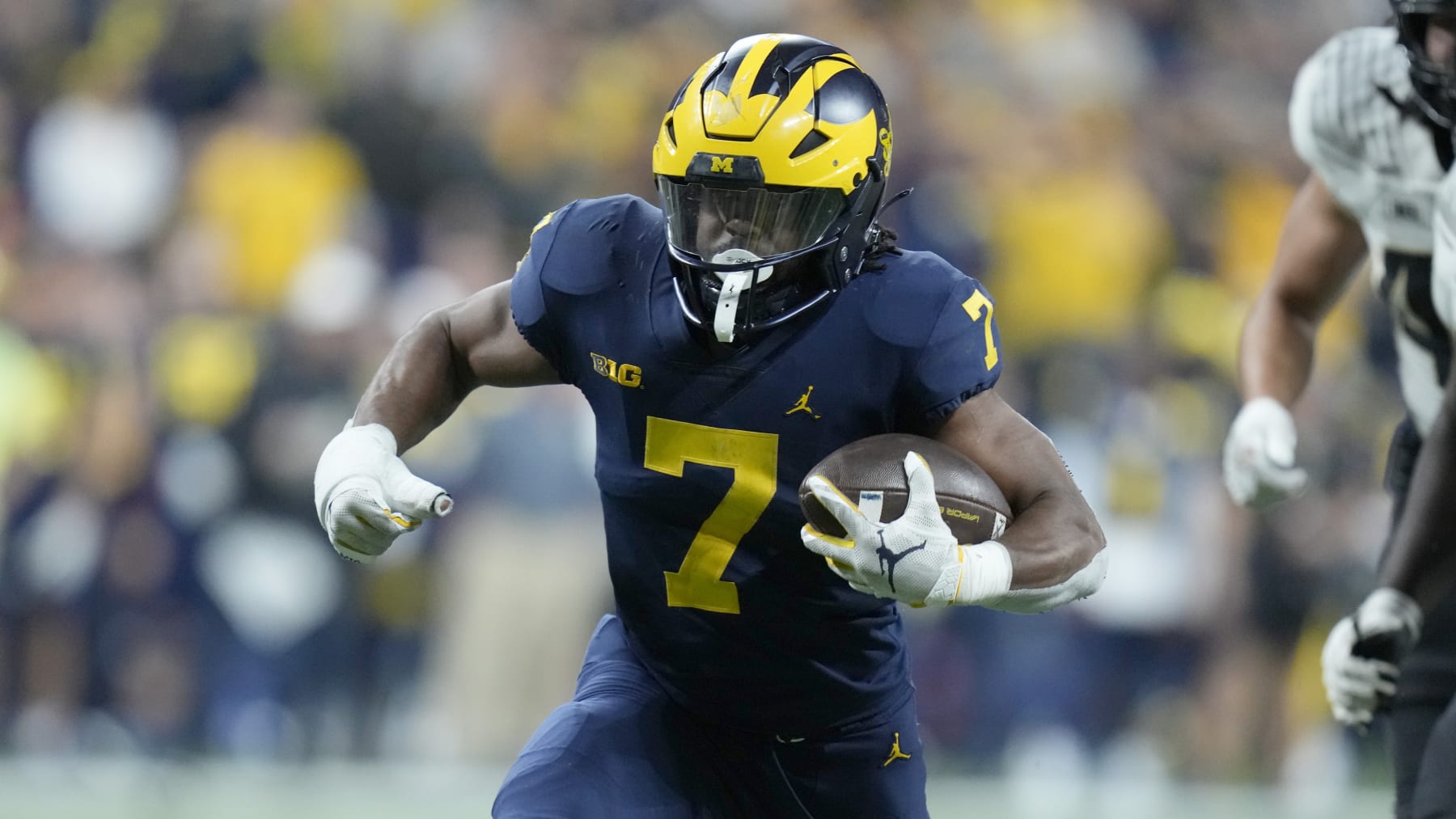 Michigan running back Donovan Edwards runs with the ball during the second half of the Big Ten championship NCAA college football game against Purdue, Saturday, Dec. 3, 2022, in Indianapolis. (AP Photo/Michael Conroy)