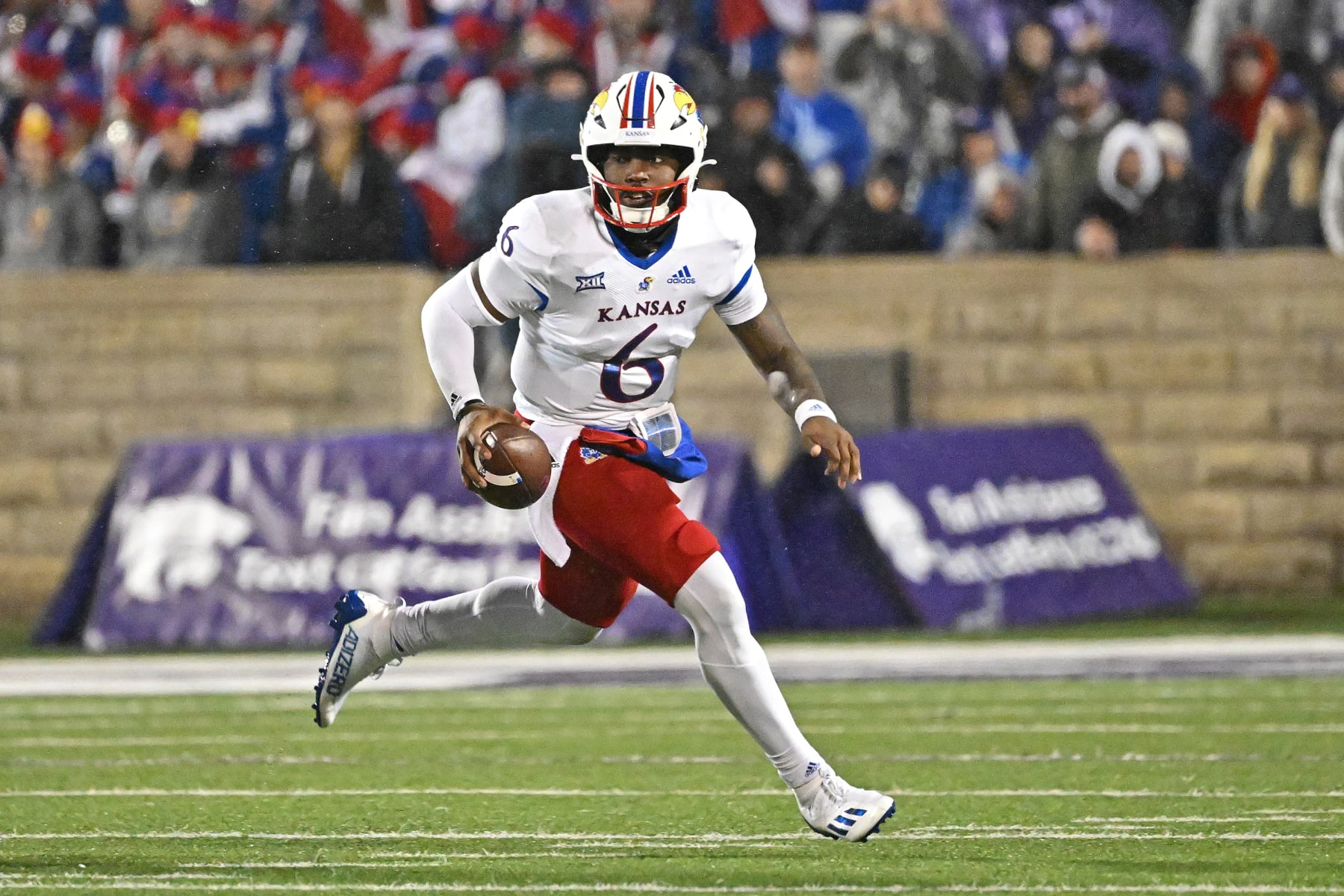 MANHATTAN, KS - NOVEMBER 26: Quarterback Jalon Daniels #6 of the Kansas Jayhawks rolls out during the first half against the Kansas State Wildcats at Bill Snyder Family Football Stadium on November 26, 2022 in Manhattan, Kansas. (Photo by Peter G. Aiken/Getty Images)