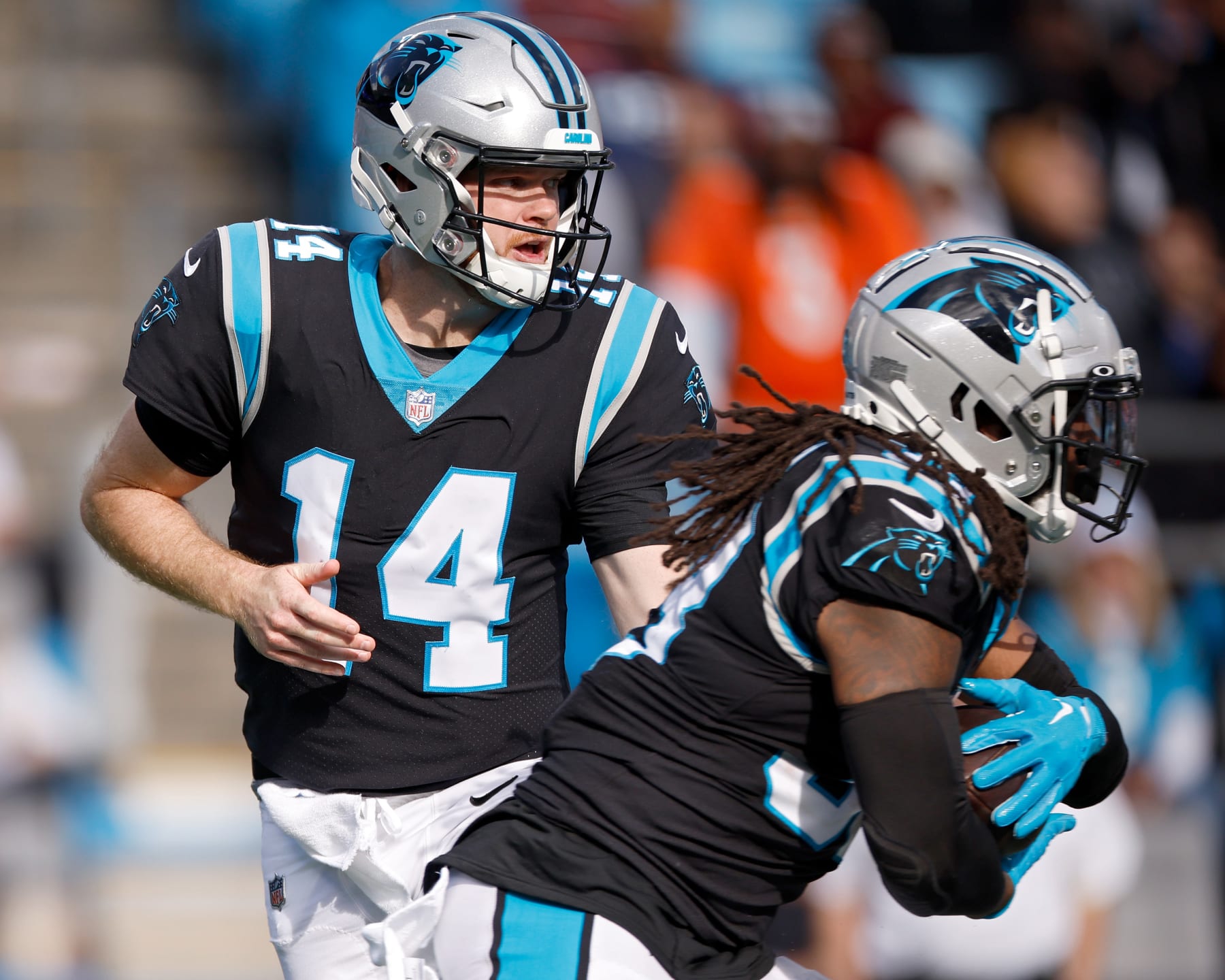 CHARLOTTE, NORTH CAROLINA - NOVEMBER 27: Sam Darnold #14 of the Carolina Panthers hands the ball to D'Onta Foreman #33 during the second half against the Denver Broncos at Bank of America Stadium on November 27, 2022 in Charlotte, North Carolina. (Photo by Jared C. Tilton/Getty Images)