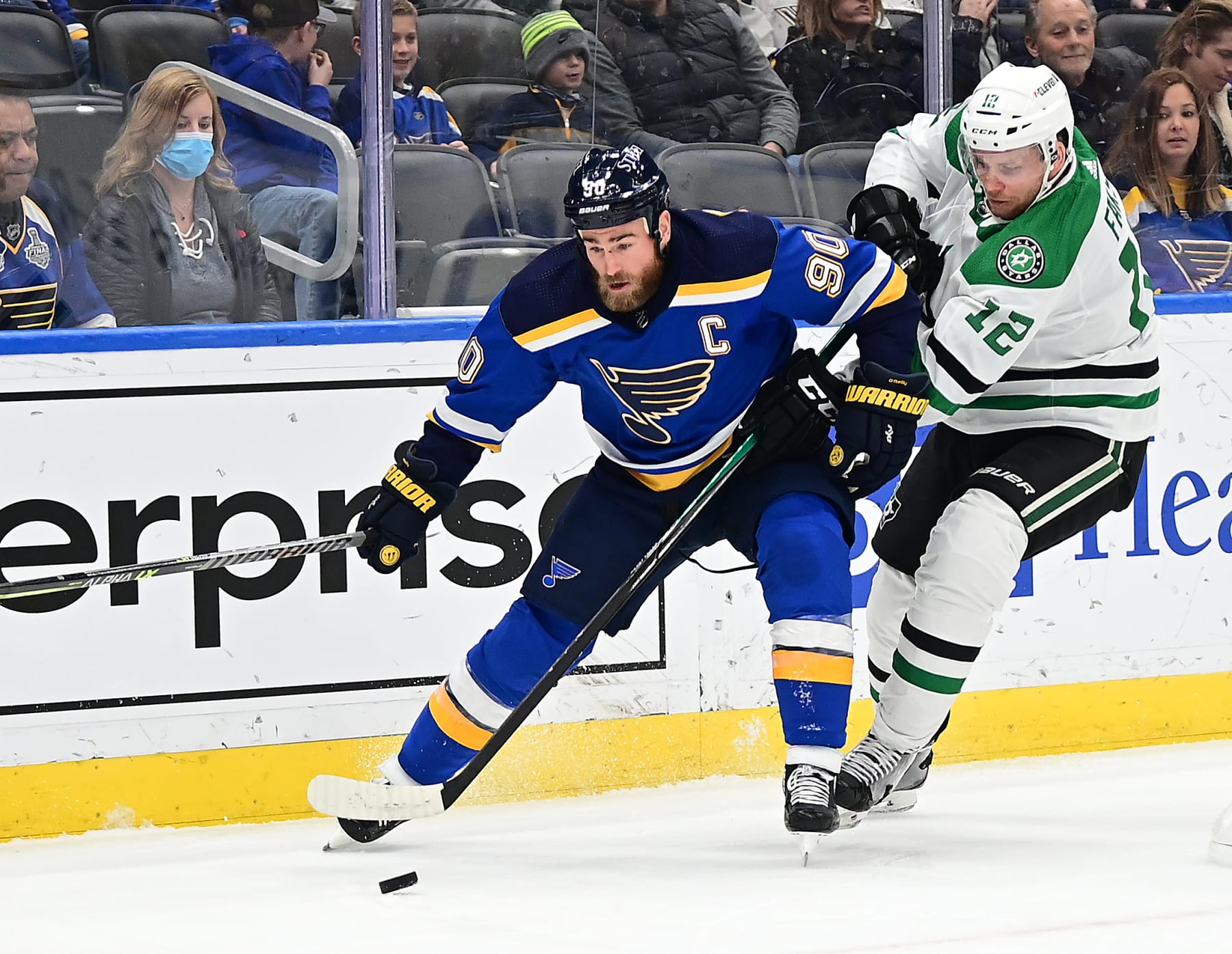 ST. LOUIS, MO - JANUARY 09: St. Louis Blues center Ryan O'Reilly (90) competes for a loose puck with Dallas Stars center Radek Faksa (12) during a NHL game between the Dallas Stars and the St. Louis Blues on January 09, 2022, at Enterprise Center, St. Louis, MO. (Photo by Keith Gillett/Icon Sportswire via Getty Images),
