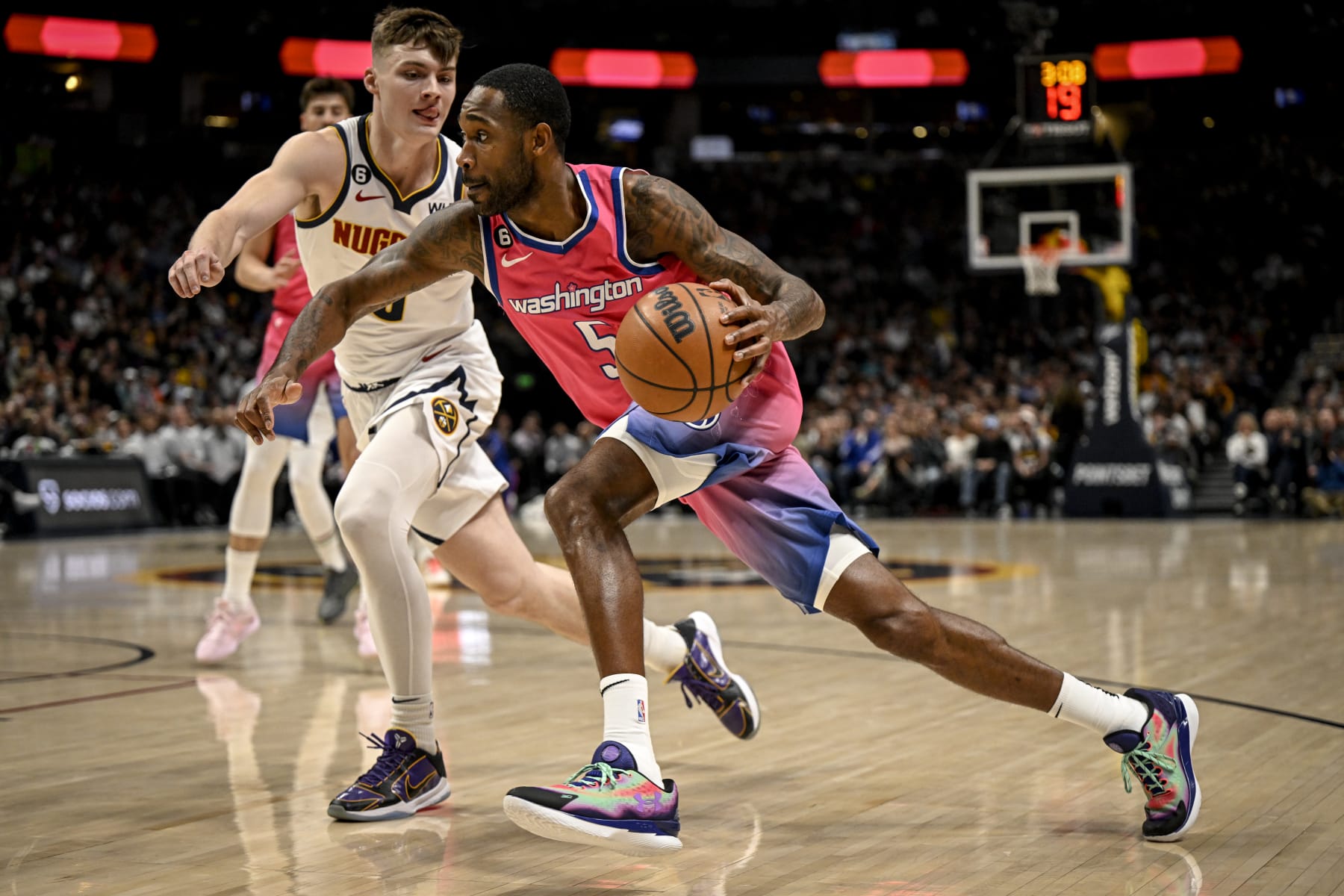 DENVER, CO - DECEMBER 14: Will Barton (5) of the Washington Wizards drives on Christian Braun (0) of the Denver Nuggets during the first quarter at Ball Arena in Denver on Wednesday, December 14, 2022. (Photo by AAron Ontiveroz/MediaNews Group/The Denver Post via Getty Images)
