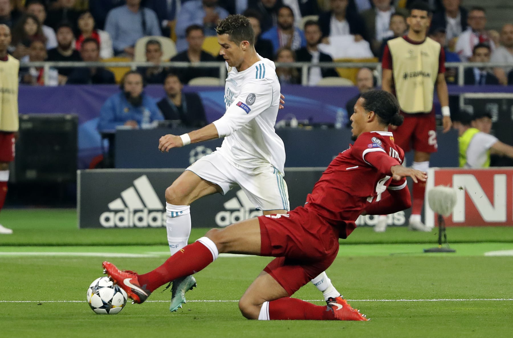 Real Madrid's Cristiano Ronaldo, left, and Liverpool's Virgil Van Dijk challenge for the ball during the Champions League Final soccer match between Real Madrid and Liverpool at the Olimpiyskiy Stadium in Kiev, Ukraine, Saturday, May 26, 2018. (AP Photo/Sergei Grits)