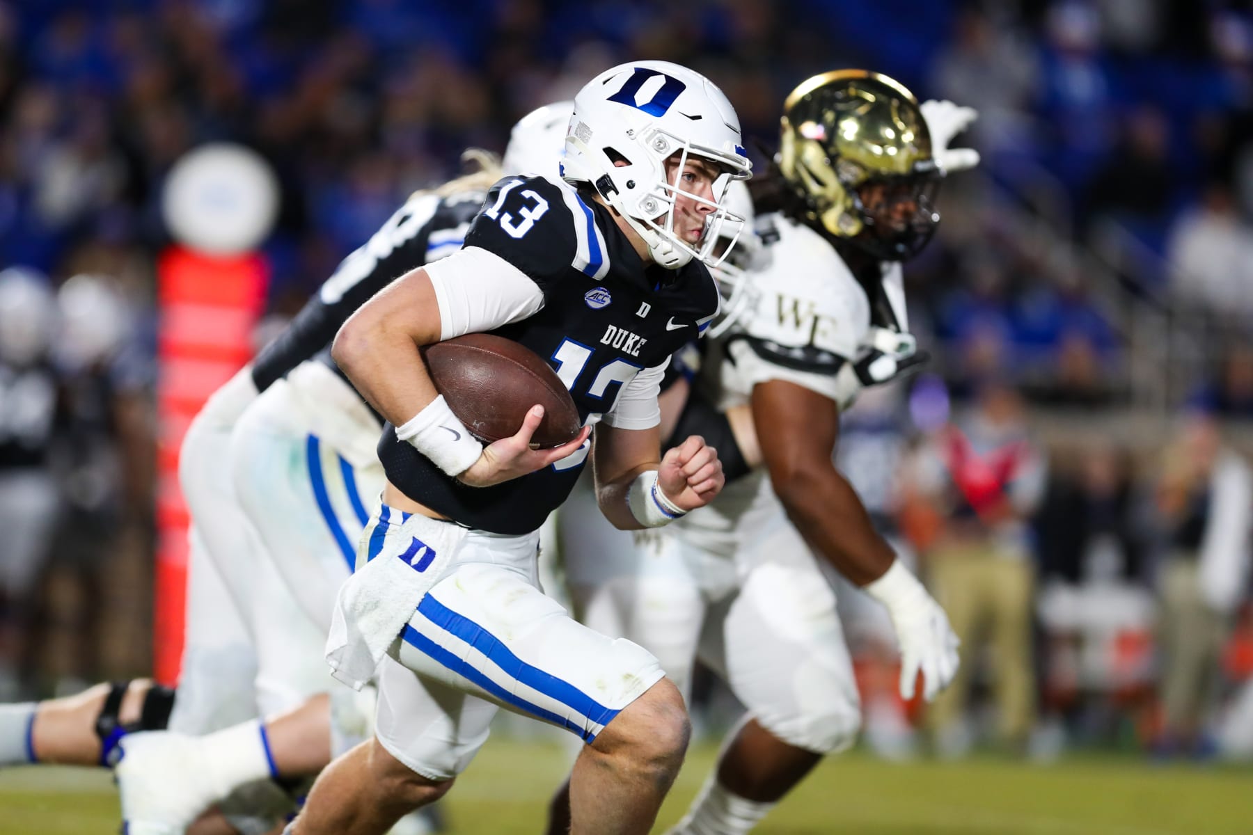 DURHAM, NC - NOVEMBER 26: Riley Leonard (13) of the Duke Blue Devils scrambles with the ball during a football game between the Duke Blue Devils and the Wake Forest Demon Deacons on Nov 26, 2022 at Wallace Wade Stadium in Durham, NC. (Photo by David Jensen/Icon Sportswire via Getty Images)