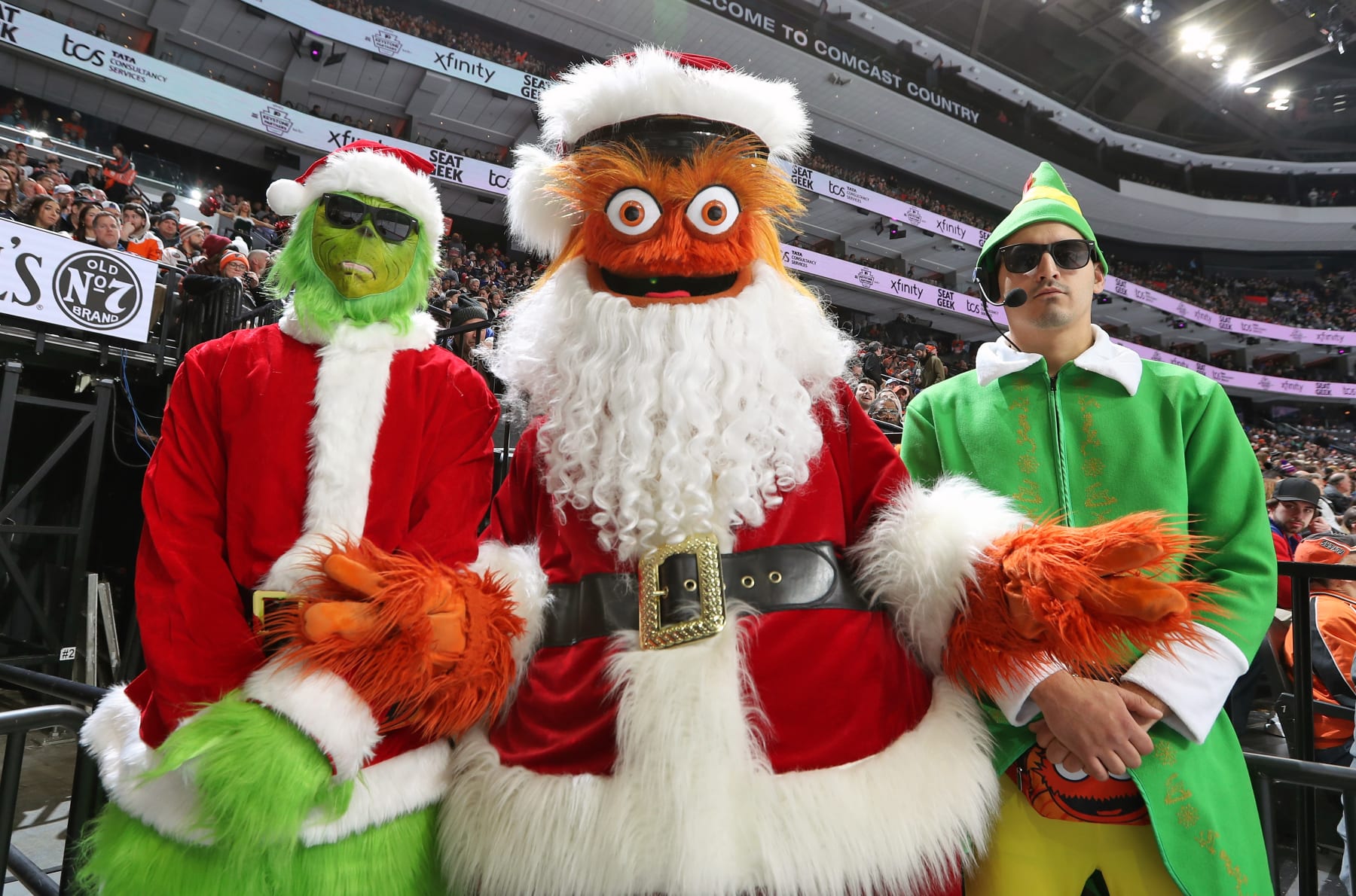 PHILADELPHIA, PENNSYLVANIA - DECEMBER 17: Gritty the mascot of the Philadelphia Flyers dressed as Santa Clause with the Holiday Body Guards pose for a photo during an NHL game against the New York Rangers at the Wells Fargo Center on December 17, 2022 in Philadelphia, Pennsylvania. (Photo by Len Redkoles/NHLI via Getty Images)