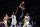 Golden State Warriors' Draymond Green (23) and Jordan Poole (3) defend a shot by Brooklyn Nets' Kevin Durant (7) during the first half of an NBA basketball game as teammate Anthony Lamb (40) watches Wednesday, Dec. 21, 2022 in New York. (AP Photo/Frank Franklin II)