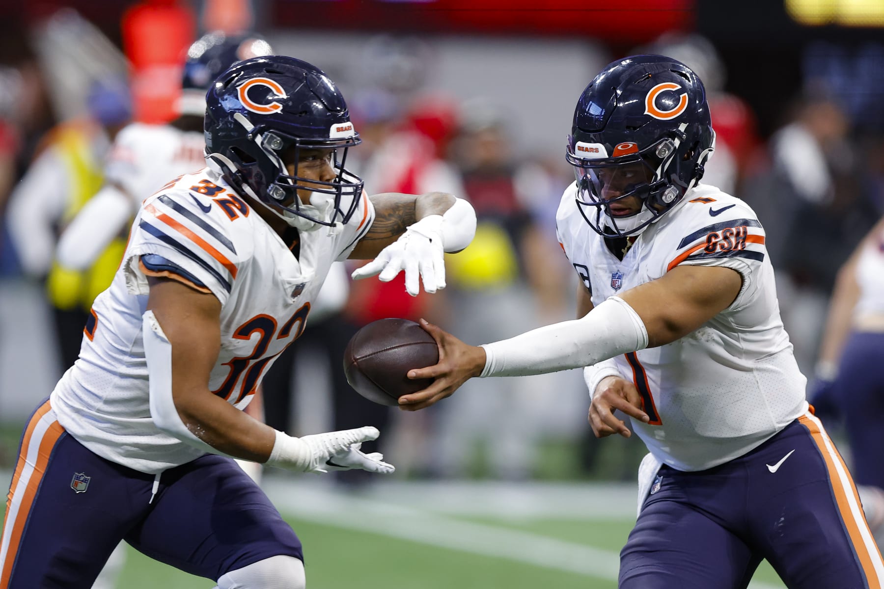 ATLANTA, GA - NOVEMBER 20: Justin Fields #1 of the Chicago Bears looks to hand off to David Montgomery #32 during the second half against the Atlanta Falcons at Mercedes-Benz Stadium on November 20, 2022 in Atlanta, Georgia. (Photo by Todd Kirkland/Getty Images)