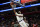 Los Angeles Lakers center Anthony Davis scores a basket past Detroit Pistons forward Isaiah Stewart, left, and center Jalen Duren during the second half of an NBA basketball game, Sunday, Dec. 11, 2022, in Detroit. (AP Photo/Jose Juarez)