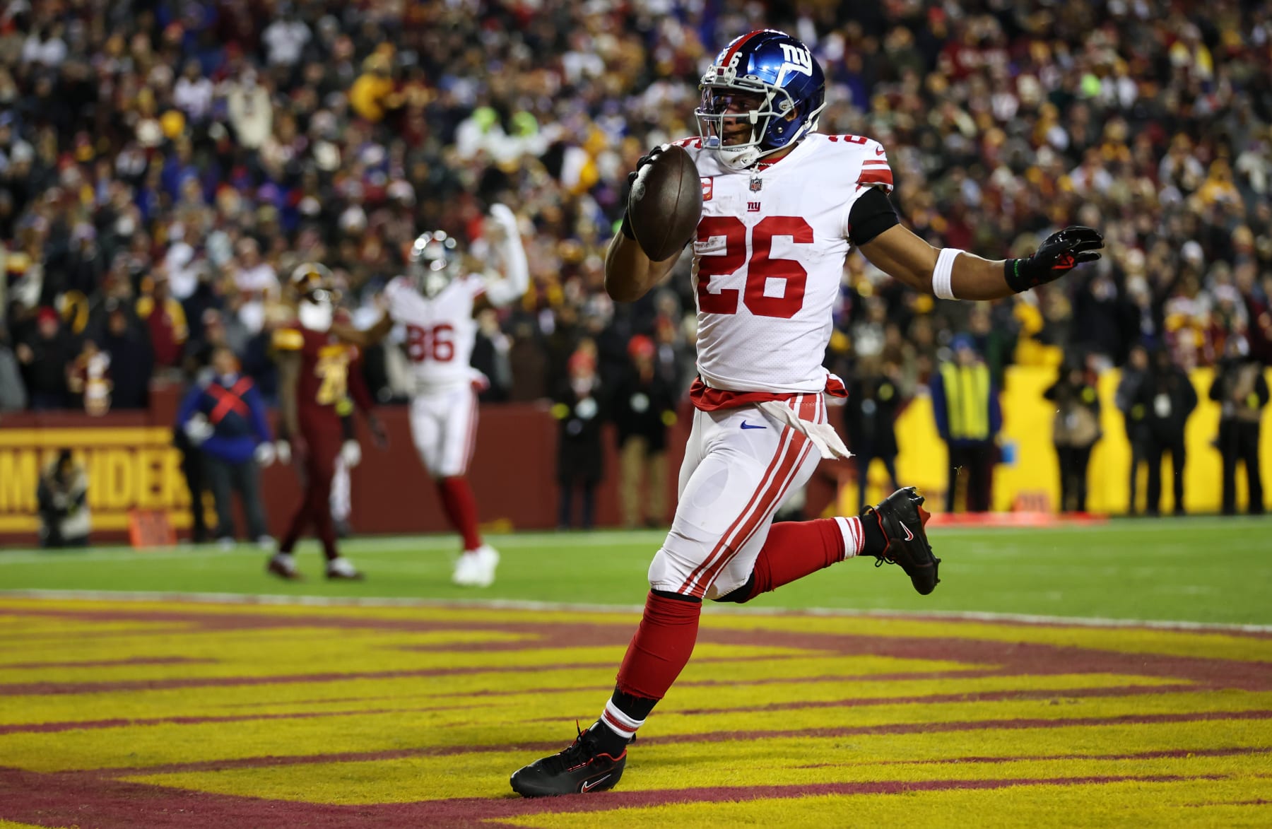 LANDOVER, MARYLAND - DECEMBER 18: Saquon Barkley #26 of the New York Giants scores a touchdown during the second quarter against the Washington Commanders at FedExField on December 18, 2022 in Landover, Maryland. (Photo by Rob Carr/Getty Images)