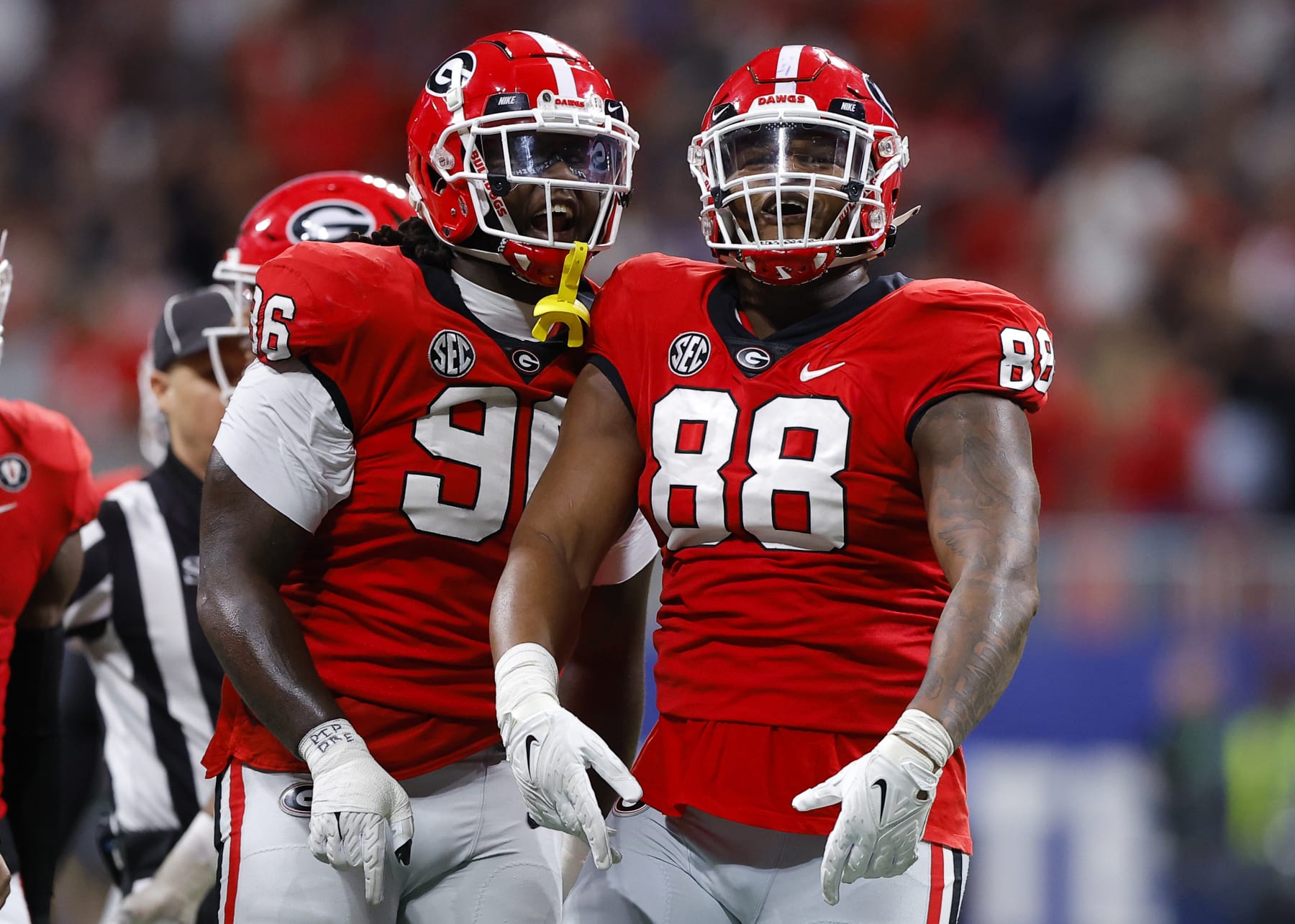 ATLANTA, GA - DECEMBER 03: Zion Logue #96 and Jalen Carter #88 of the Georgia Bulldogs reacts after a stop against the LSU Tigers during the first half of the SEC Championship game at Mercedes-Benz Stadium on December 3, 2022 in Atlanta, Georgia. (Photo by Todd Kirkland/Getty Images)