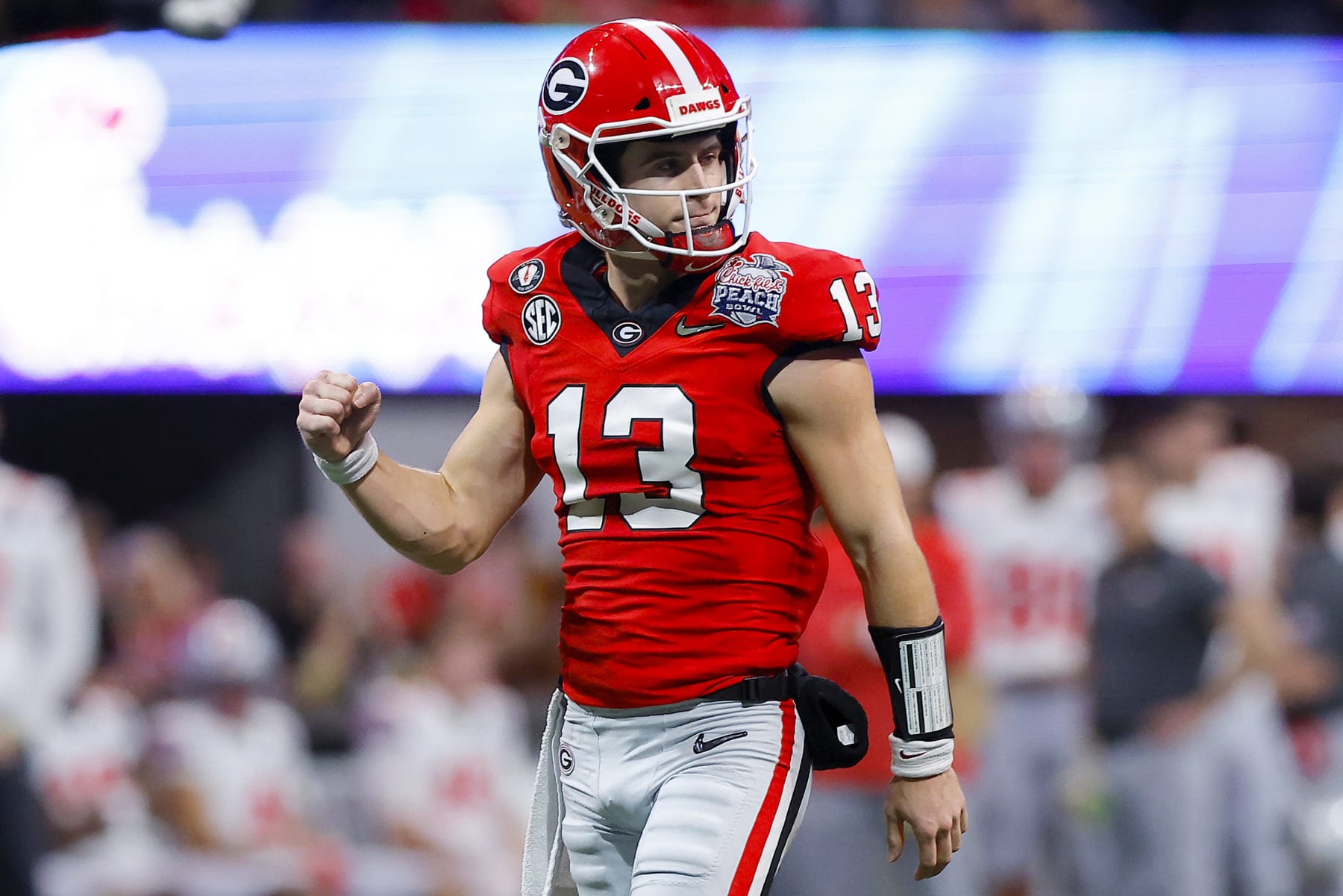 ATLANTA, GEORGIA - DECEMBER 31: Stetson Bennett #13 of the Georgia Bulldogs reacts after a touchdown during the first quarter against the Ohio State Buckeyes in the Chick-fil-A Peach Bowl at Mercedes-Benz Stadium on December 31, 2022 in Atlanta, Georgia. (Photo by Todd Kirkland/Getty Images)