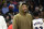 Washington Wizards guard Bradley Beal wears street clothes during a break in the second half of the team's NBA basketball game against the Phoenix Suns, Wednesday, Dec. 28, 2022, in Washington. Beal did not play due to injury. The Wizards won 127-102. (AP Photo/Nick Wass)