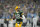 GREEN BAY, WISCONSIN - JANUARY 08: Aaron Rodgers #12 of the Green Bay Packers scrambles with the ball against the Detroit Lions in the first half at Lambeau Field on January 08, 2023 in Green Bay, Wisconsin. (Photo by Patrick McDermott/Getty Images)