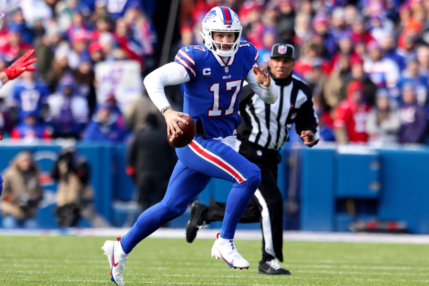 ORCHARD PARK, NEW YORK - JANUARY 15: Josh Allen #17 of the Buffalo Bills scrambles during the first half of the game against the Miami Dolphins in the AFC Wild Card playoff game at Highmark Stadium on January 15, 2023 in Orchard Park, New York. (Photo by Bryan M. Bennett/Getty Images)