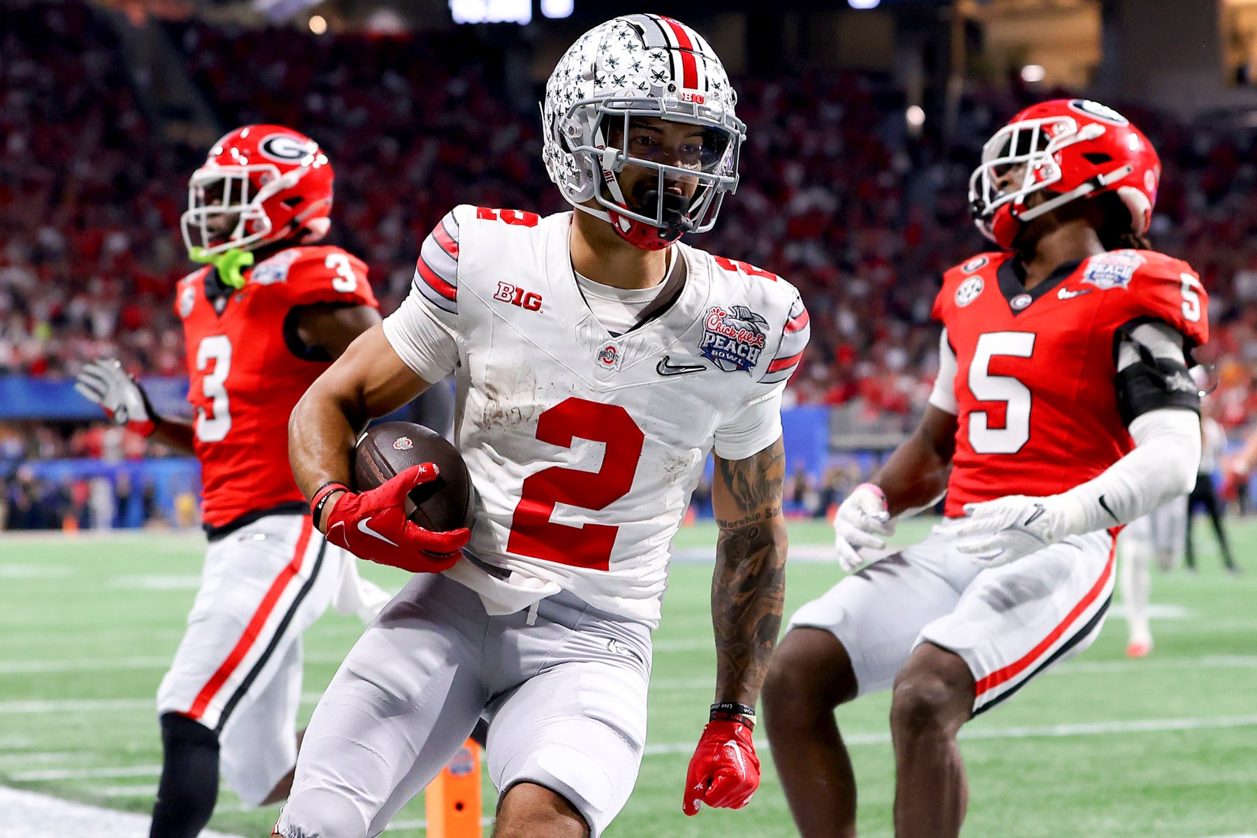 Football Football ATLANTA, GEORGIA - DECEMBER 31: Emeka Egbuka #2 of the Ohio State Buckeyes reacts after scoring a touchdown during the third quarter against the Georgia Bulldogs in the Chick-fil-A Peach Bowl at Mercedes-Benz Stadium on December 31, 2022 in Atlanta, Georgia. (Photo by Kevin C. Cox/Getty Images)