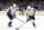 BOSTON, MA - FEBRUARY 11: Washington Capitals right wing Garnet Hathaway (21) grabs the puck watched by defenseman Dmitry Orlov (9) during a game between the Boston Bruins and the Washington Capitals on February 11, 2023, at TD Garden in Boston, Massachusetts. (Photo by Fred Kfoury III/Icon Sportswire via Getty Images)