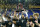 Texas A&M Corpus Christi forward Isaac Mushila hoists the championship trophy after the team defeated Northwestern State during an NCAA college basketball game in the finals of the Southland Conference men's tournament in Lake Charles, La., Wednesday, March 8, 2023. (AP Photo/Matthew Hinton)