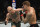 ABU DHABI, UNITED ARAB EMIRATES - JANUARY 23: In this handout image provided by the UFC, (L-R) Conor McGregor of Ireland punches Dustin Poirier in a lightweight fight during the UFC 257 event inside Etihad Arena on UFC Fight Island on January 23, 2021 in Abu Dhabi, United Arab Emirates. (Photo by Jeff Bottari/Zuffa LLC via Getty Images)