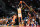 HOUSTON, TEXAS - MARCH 28: DJ Wagner #21of the East team attempts a three point shot over Baye Fall #21 of the West team in the 2023 McDonald's High School All-American Game at Toyota Center on March 28, 2023 in Houston, Texas. (Photo by Alex Bierens de Haan/Getty Images)