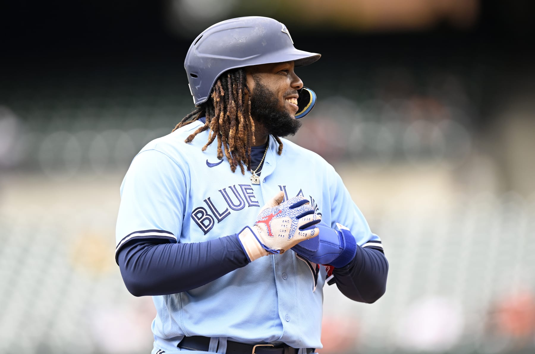 BALTIMORE, MARYLAND - OCTOBER 05: Vladimir Guerrero Jr. #27 of the Toronto Blue Jays stands on first base against the Baltimore Orioles during game one of a doubleheader at Oriole Park at Camden Yards on October 05, 2022 in Baltimore, Maryland. (Photo by G Fiume/Getty Images)