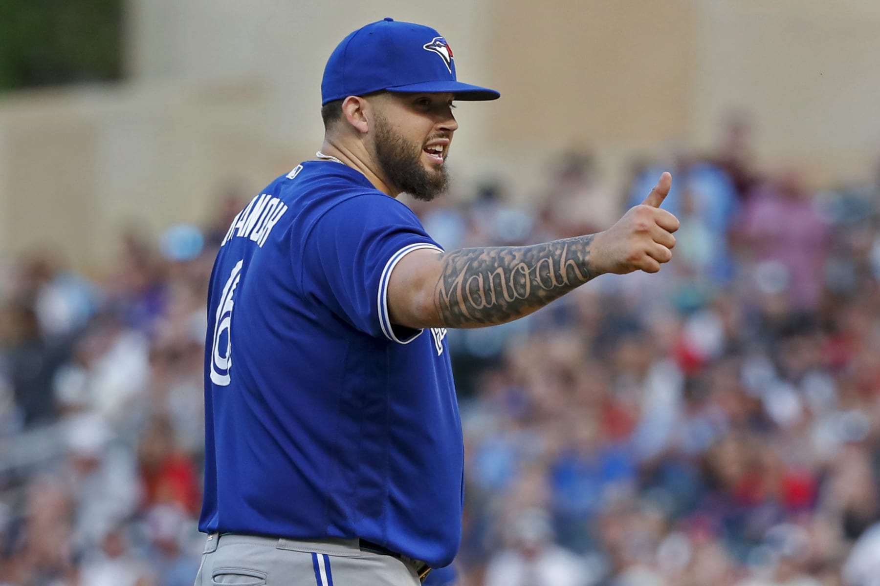 Toronto Blue Jays starting pitcher Alek Manoah signals to the bench that he is okay after getting struck by a base hit by Minnesota Twins' Carlos Correa during the fourth inning of a baseball game Thursday, Aug. 4, 2022, in Minneapolis. (AP Photo/Bruce Kluckhohn)
