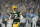 GREEN BAY, WISCONSIN - JANUARY 08: Aaron Rodgers #12 of the Green Bay Packers scrambles with the ball against the Detroit Lions in the first half at Lambeau Field on January 08, 2023 in Green Bay, Wisconsin. (Photo by Patrick McDermott/Getty Images)