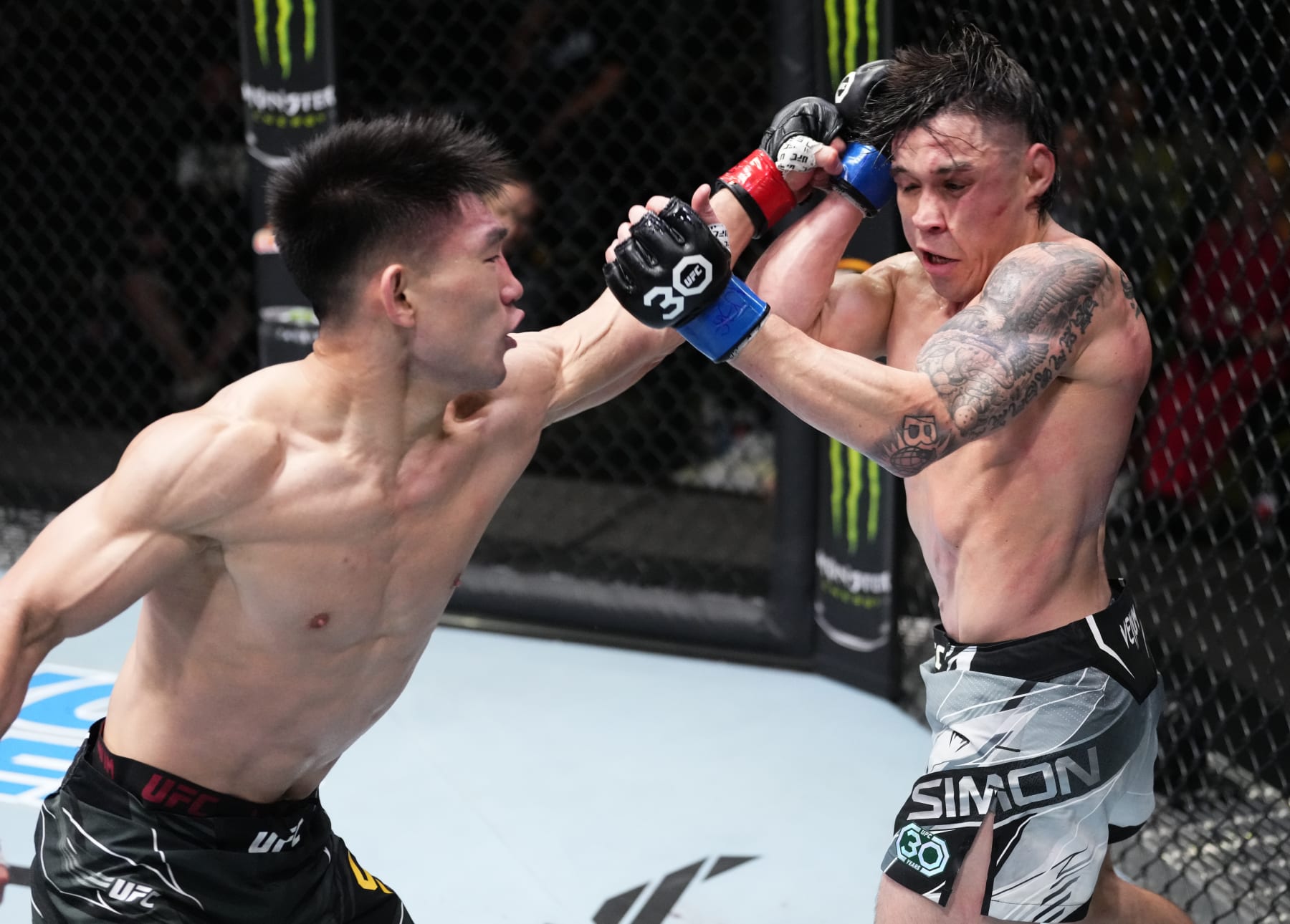 LAS VEGAS, NEVADA - APRIL 29: (L-R) Song Yadong of China punches Ricky Simon in a bantamweight fight during the UFC Fight Night event at UFC APEX on April 29, 2023 in Las Vegas, Nevada. (Photo by Jeff Bottari/Zuffa LLC via Getty Images)