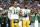 MIAMI GARDENS, FL - DECEMBER 25: Aaron Rodgers #12 of the Green Bay Packers links arms with Randall Cobb #18 on the sidelines during the national anthem before an NFL football game against the Miami Dolphins at Hard Rock Stadium on December 25, 2022 in Miami Gardens, Florida. (Photo by Kevin Sabitus/Getty Images)