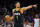 Phoenix Suns guard Devin Booker (1) calls a play during the first half of Game 3 of an NBA basketball Western Conference semifinal game against the Denver Nuggets, Friday, May 5, 2023, in Phoenix. (AP Photo/Matt York)