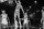 (Original Caption) Royals-76'ers. Cleveland, Ohio: Oscar Robertson (14) of Cincinnati watches Wilt Chamberlain of Philadelphia dunk one in 1st quarter action here February 17th.