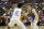 Golden State Warriors' Brandin Podziemski, right, drives against Los Angeles Lakers' Jalen Hood-Schifino during the first half of an NBA summer league basketball game Friday, July 7, 2023, in Las Vegas. (AP Photo/John Locher)