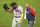 Atlanta Braves' Ronald Acuña Jr., left, leaves the field with a team trainer after being hit by a pitch from Pittsburgh Pirates reliever Colin Holderman during the sixth inning of a baseball game in Pittsburgh, Tuesday, Aug. 8, 2023. (AP Photo/Gene J. Puskar)