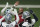 Dallas Cowboys quarterback Dak Prescott, center, high fives running backs Rico Dowdle (23), Deuce Vaughn and other teammates during NFL football practice in Frisco, Texas, Thursday, June 1, 2023. (AP Photo/LM Otero)