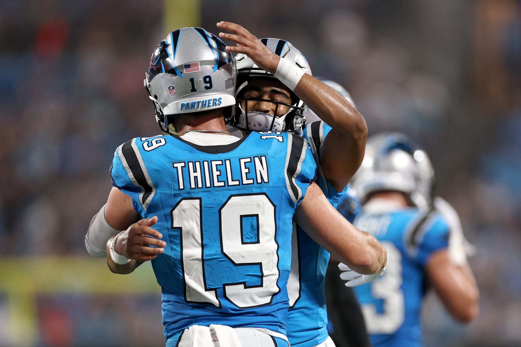 Bryce Young celebrates his first NFL touchdown throw with Adam Thielen.