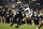 Colorado quarterback Shedeur Sanders, left, eludes a tackle by Colorado State defensive lineman Nuer Gatkuoth in the second half of an NCAA college football game Saturday, Sept. 16, 2023, in Boulder, Colo. (AP Photo/David Zalubowski)