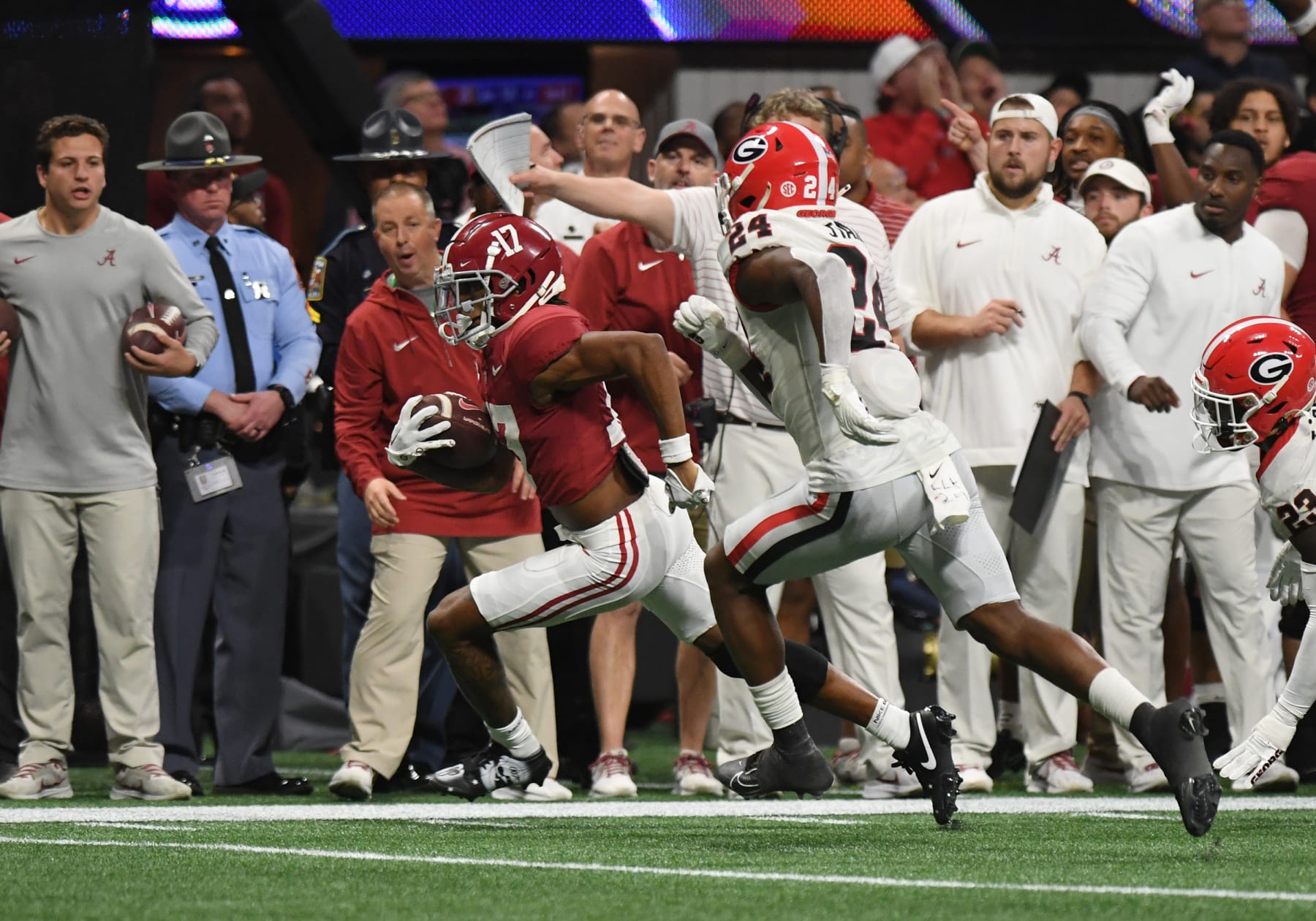 ATLANTA, GA - DECEMBER 02: Alabama Crimson Tide Wide Receiver Isaiah Bond (17) hurries the ball as Georgia Bulldogs Defensive Back Malaki Starks (24) protects throughout the SEC Championship Game in between the Georgia Bulldogs and the Alabama Crimson Tide on December 02, 2023, at Mercedes-Benz Stadium in Atlanta, GA. (Photo by Jeffrey Vest/Icon Sportswire through Getty Images)