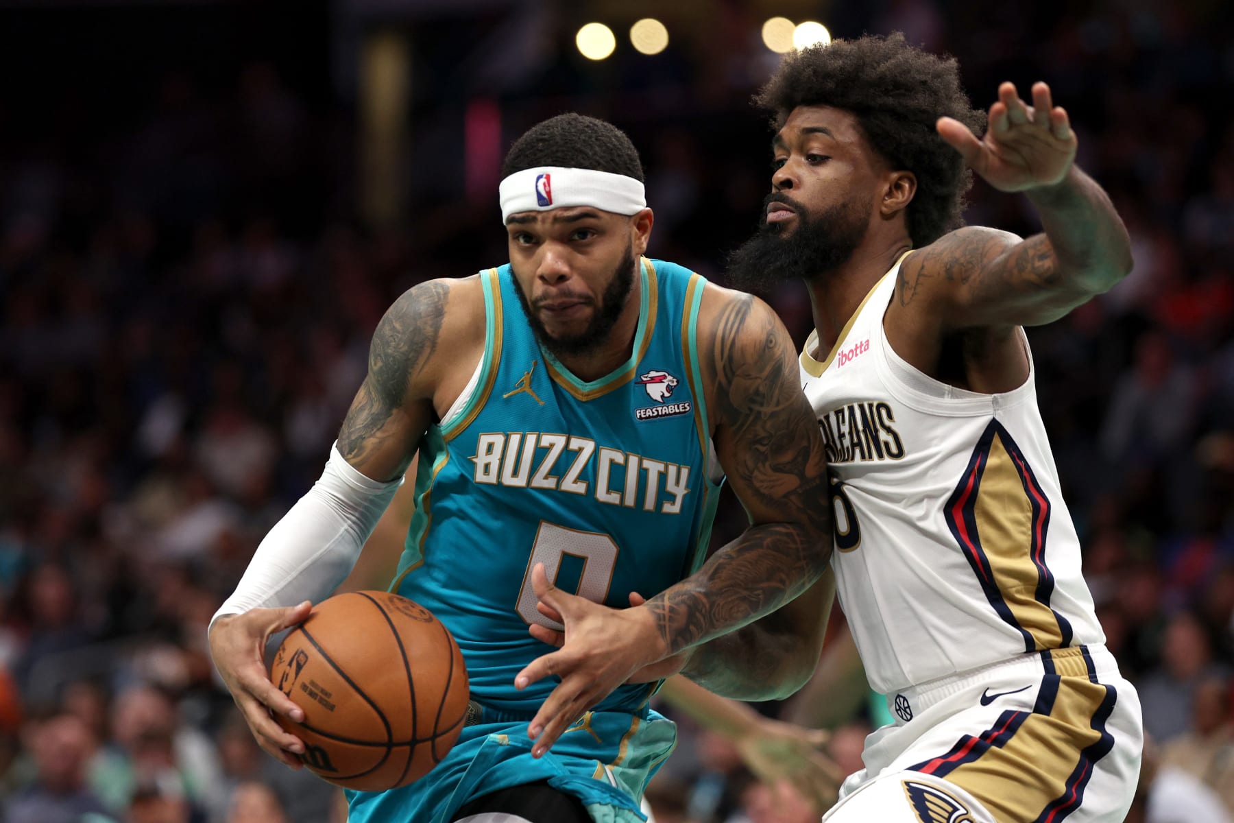 CHARLOTTE, NORTH CAROLINA - DECEMBER 15:  Miles Bridges #0 of the Charlotte Hornets drives to the basket against Naji Marshall #8 of the New Orleans Pelicans during the second half of the game at Spectrum Center on December 15, 2023 in Charlotte, North Carolina. NOTE TO USER: User expressly acknowledges and agrees that, by downloading and or using this photograph, User is consenting to the terms and conditions of the Getty Images License Agreement. (Photo by Jared C. Tilton/Getty Images)