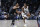 Memphis Grizzlies guard Ja Morant (12) looks to pass around New Orleans Pelicans guard CJ McCollum (3) in the first half of an NBA basketball game in New Orleans, Tuesday, Dec. 19, 2023. (AP Photo/Gerald Herbert)