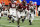 ATLANTA, GEORGIA - DECEMBER 2: Jalen Milroe #4 of the Alabama Crimson Tide avoids the Georgia pass rush during a game between University of Georgia and University of Alabama at Mercedes-Benz Stadium on December 2, 2023 in Atlanta, Georgia. (Photo by Steve Limentani/ISI Photos/Getty Images)